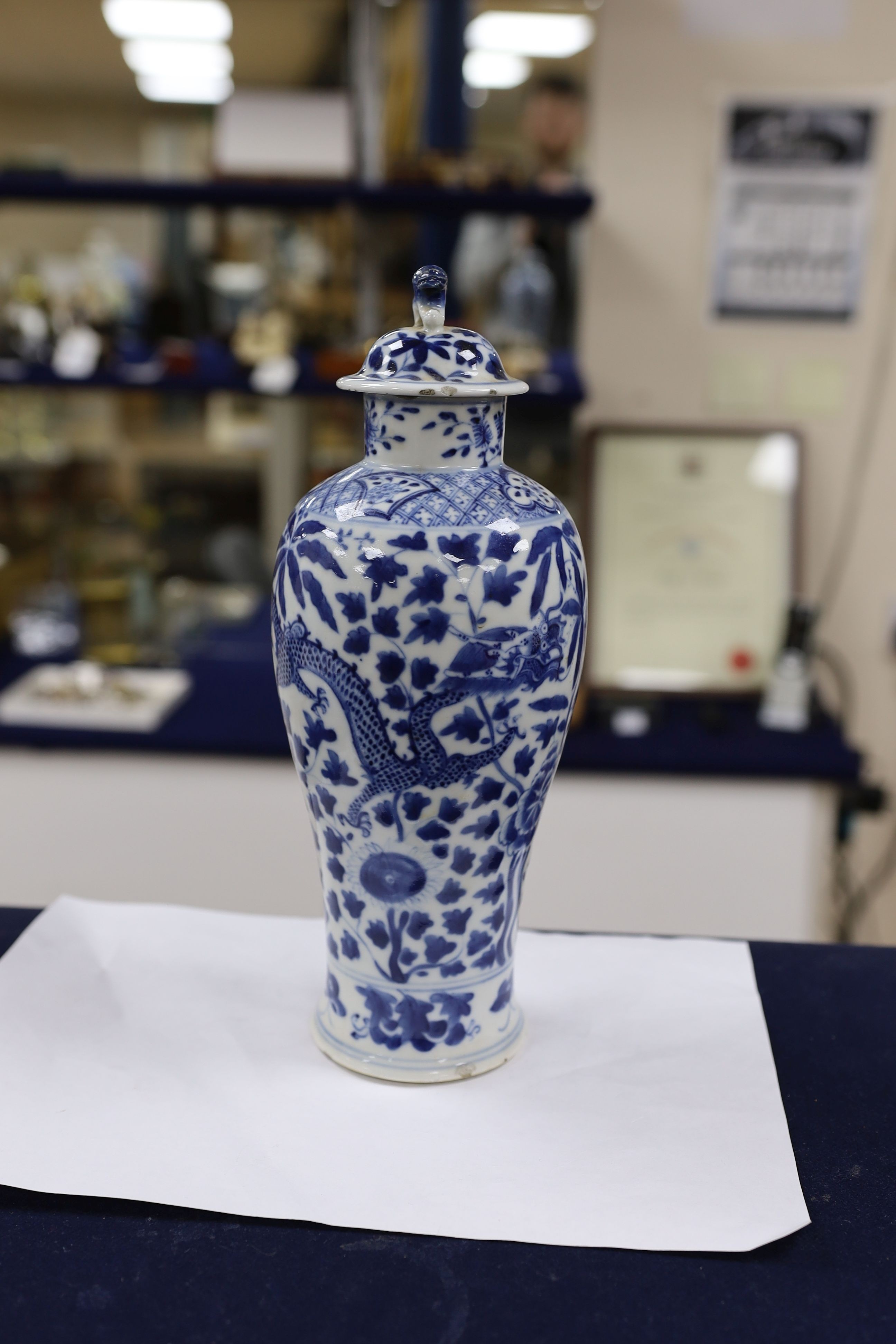 A pair of Chinese blue and white dragon vases and covers, circa 1900. 28cm